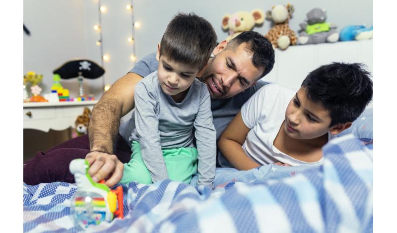 Father Playing with Kids in Bedroom